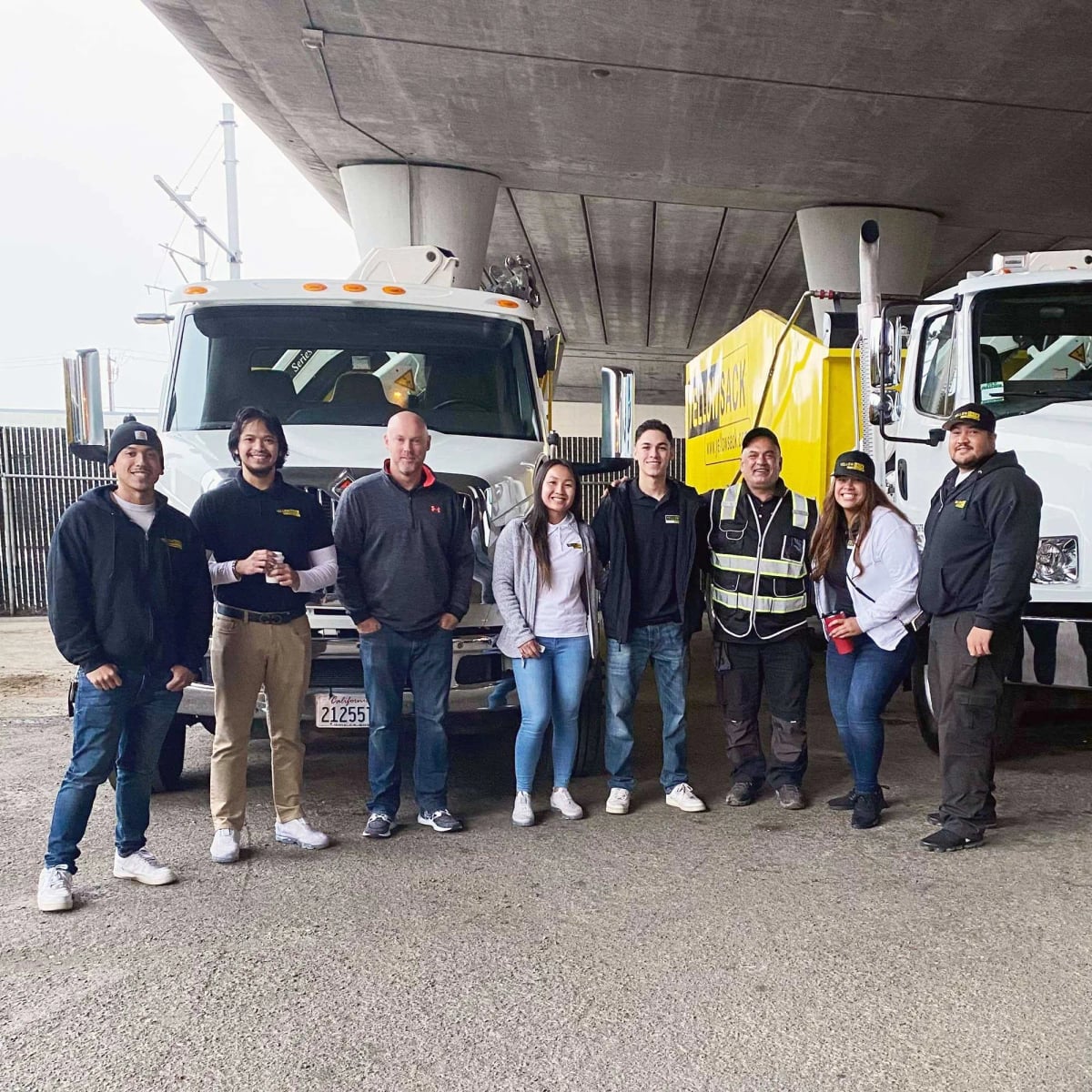 Yellowsack drivers and crane operators with their trucks