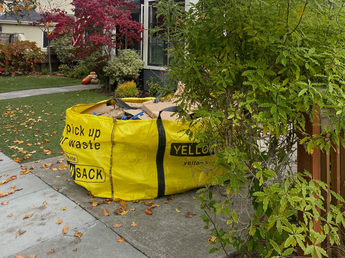 A homeowner filling a Yellowsack with debris